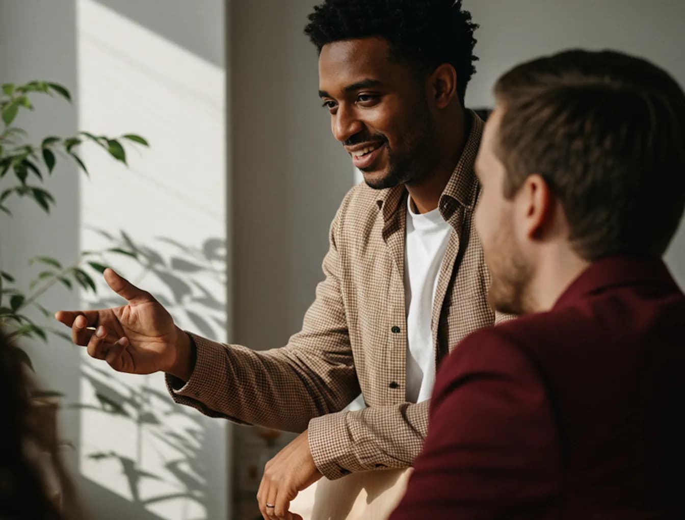 Smiling woman sitting at a desk in warm sunlight